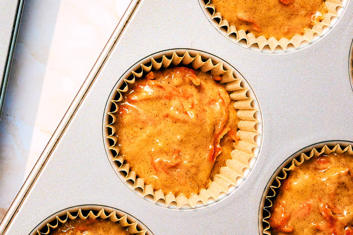 Vegan Banana Carrot Muffin batter in muffin tin before baking.