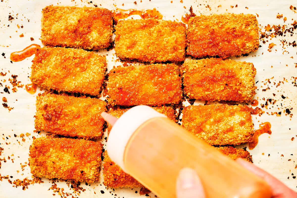 Nashville Hot Oil being drizzled over crispy oven baked tofu.
