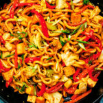 Vegan Yaki Udon with tofu and vegetables in a skillet.