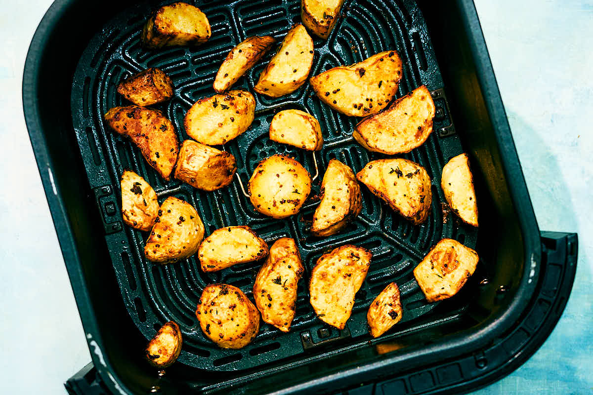Easy roasted parsnips in an Air Fryer basket after baking.