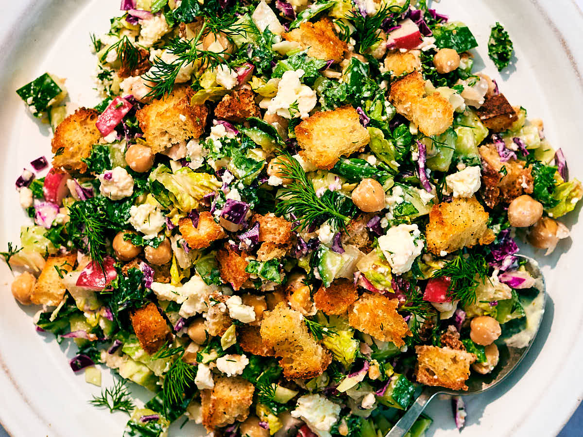 Chopped Dill Pickle Ranch Salad with kale, cabbage, croutons, feta, and chickpeas.