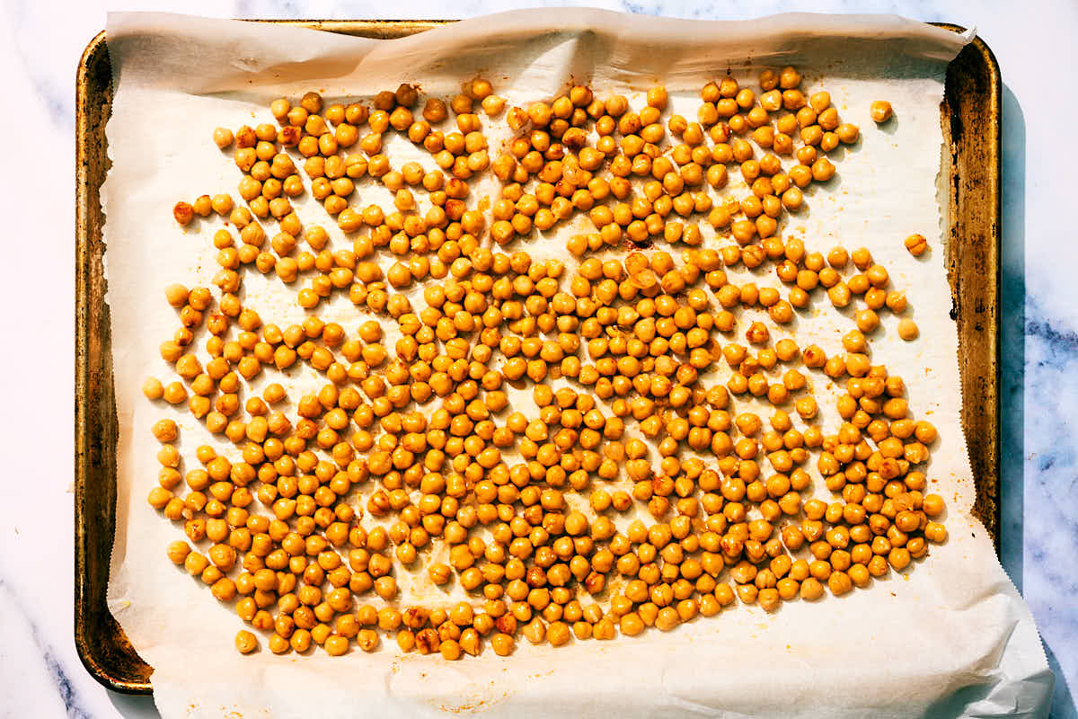 Roasted chickpeas on a baking sheet.