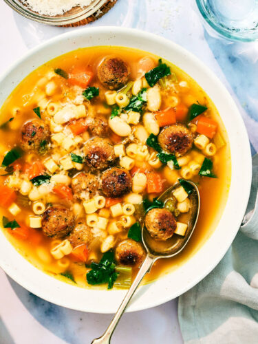 Vegan Italian Wedding Soup in a bowl with a spoon.