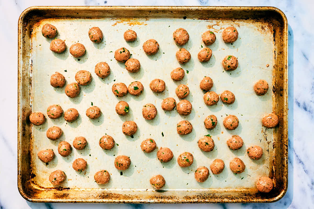 Vegan mini meatballs on a baking sheet before getting baked in the oven.