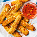 Easy Air Fryer Halloumi Friers with Hot Honey Sauce on a blue plate.