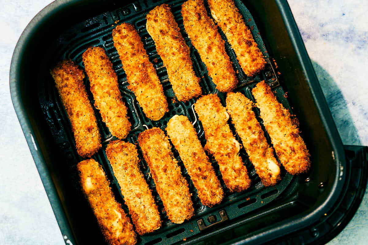 Crispy Air Fryer Halloumi Fries in an air fryer basket after baking.