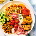Greek Veggie Feta Bowls with tzatziki, crispy chickpeas, dill, and marinated onions.