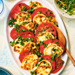 Seared Halloumi and Tomato Salad with herb gremolata on a serving plate.