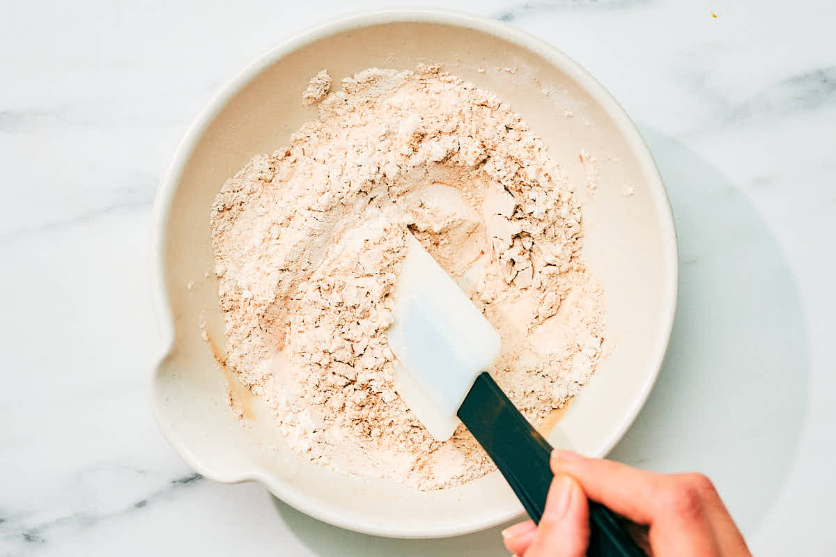 Mixing together dry ingredients for cottage cheese pancakes recipe.
