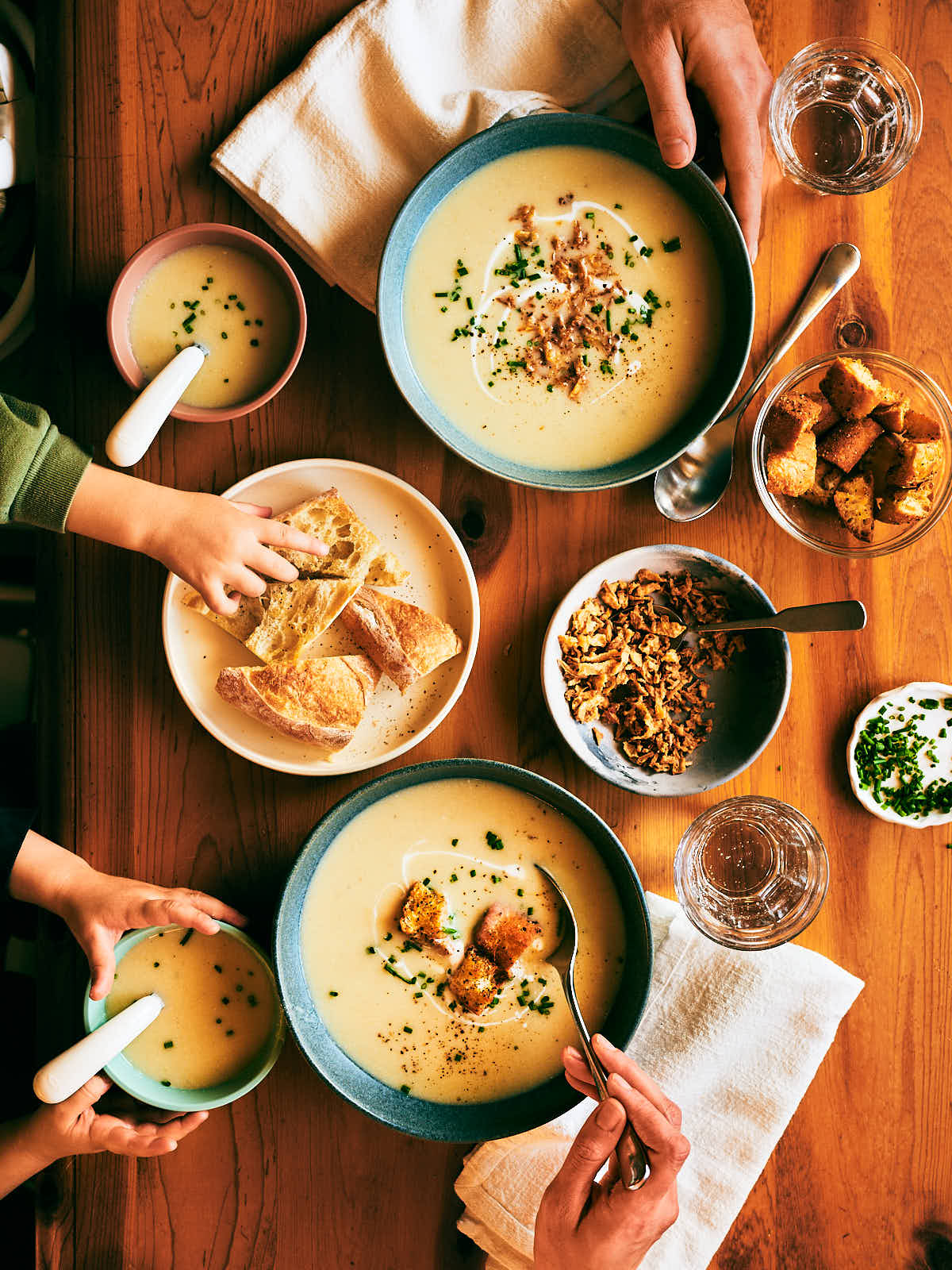 A family eating slow Cooker Potato Leek Soup at the dinner table.