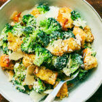 Easy Broccoli Caesar Salad (without anchovies, egg, or mayo) in a bowl with a fork.