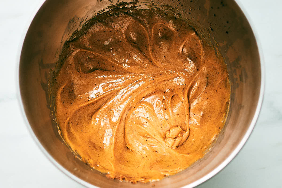 Chocolate Chip and Pecan cookie batter being made in a bowl.