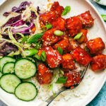 Easy Gochujang Tofu with rice, cucumber, and cabbage.