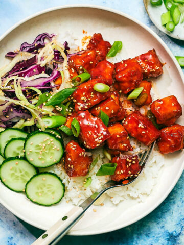 Easy Gochujang Tofu with rice, cucumber, and cabbage.