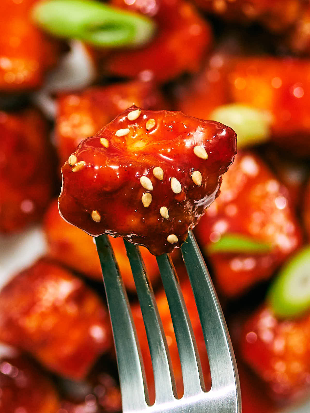 Evergreen Kitchen's high protein Gochujang Tofu on a fork.