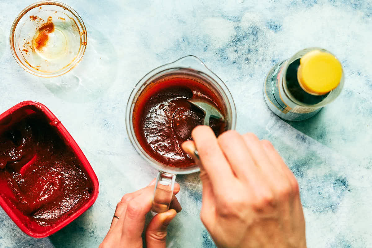 Easy gochujang sauce being mixed in a glass jar.