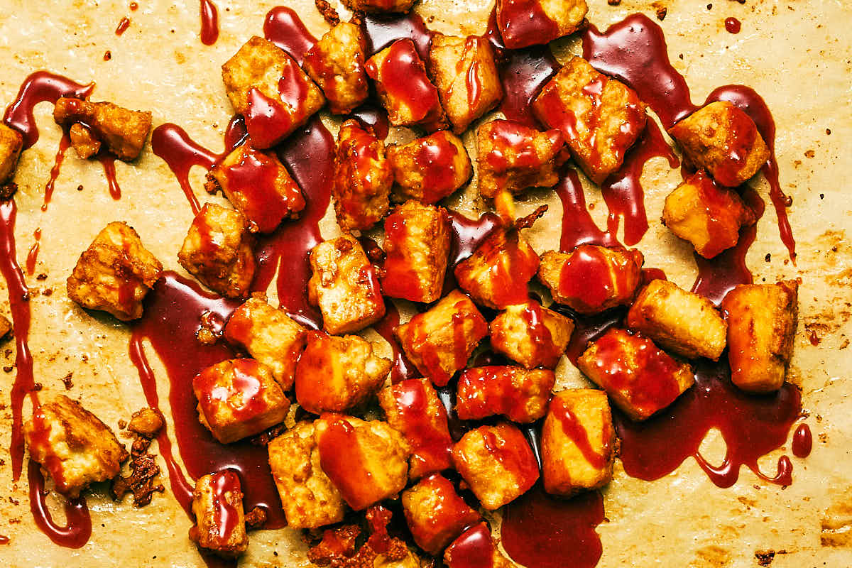 Gochujang sauce drizzled over oven baked tofu.