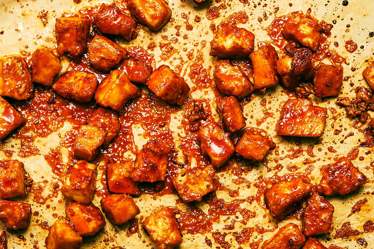 Evergreen Kitchen's easy Gochujang Tofu on a parchment lined baking sheet.