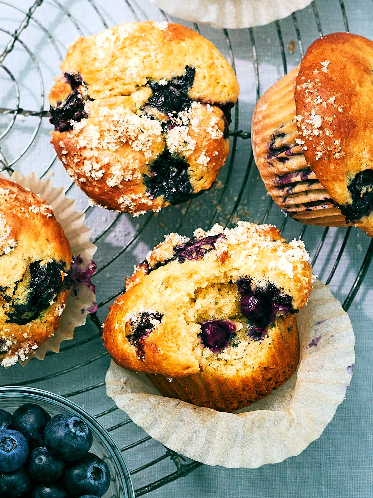 Blueberry Cottage Cheese Muffins with lemon sugar on a cooling rack.
