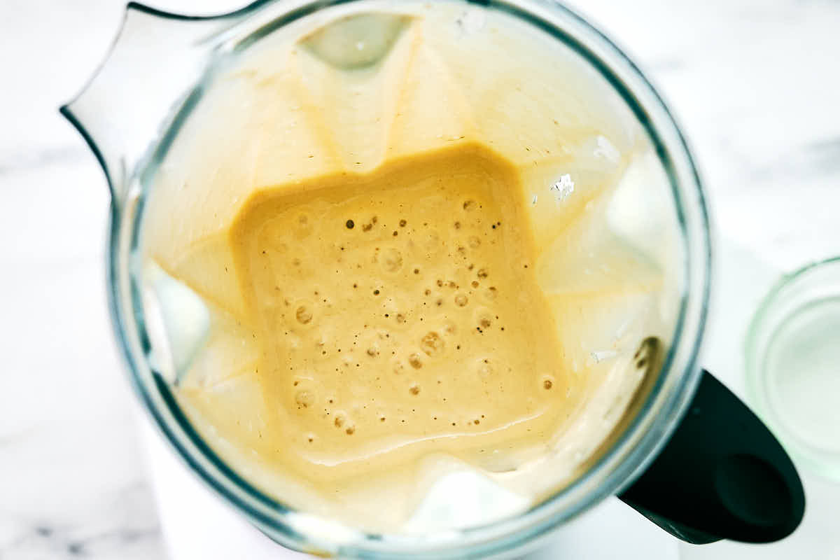 Wet ingredients in a blender container for banana cottage cheese muffins.