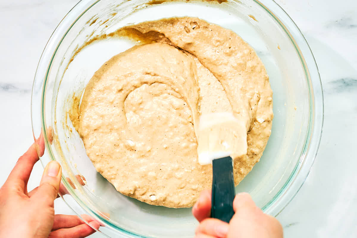 Banana Cottage Cheese Muffin batter being stirred together in glass bowl.
