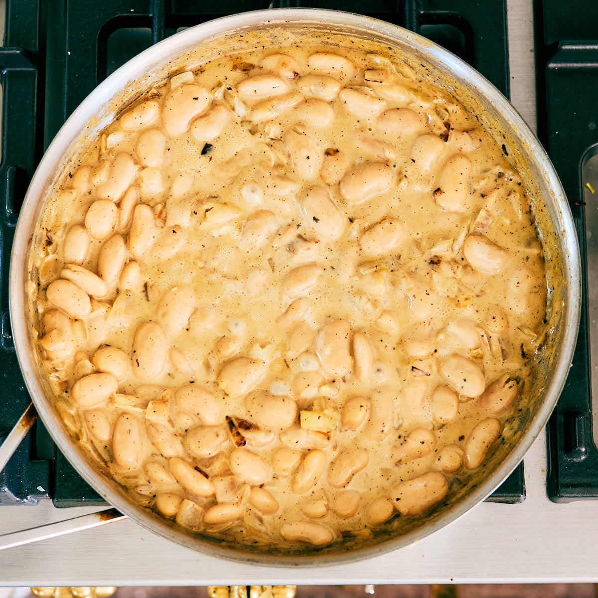 Creamy Lemon Butter Beans simmering in a skillet.