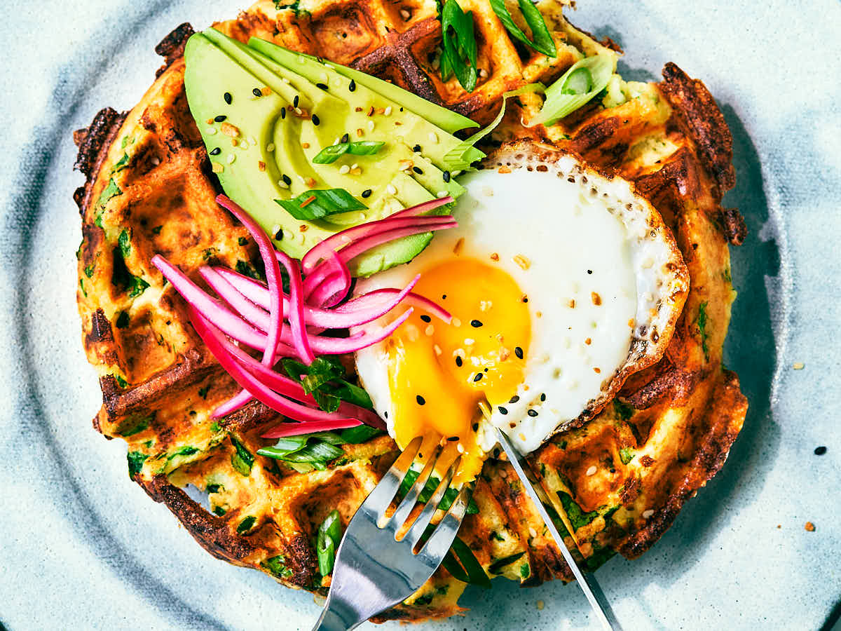 Savory High Protein Cottage Cheese Waffles topped with egg, avocado, pickled onions.