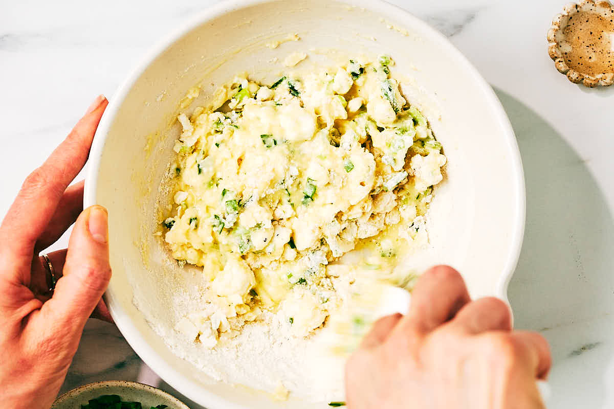 Savory high protein waffle batter being mixed in a bowl.