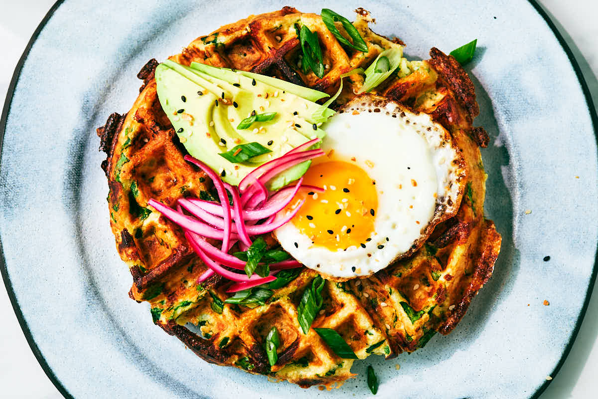 Savory High Protein Waffles with Cottage Cheese topped with egg, avocado, and pickled red onion.