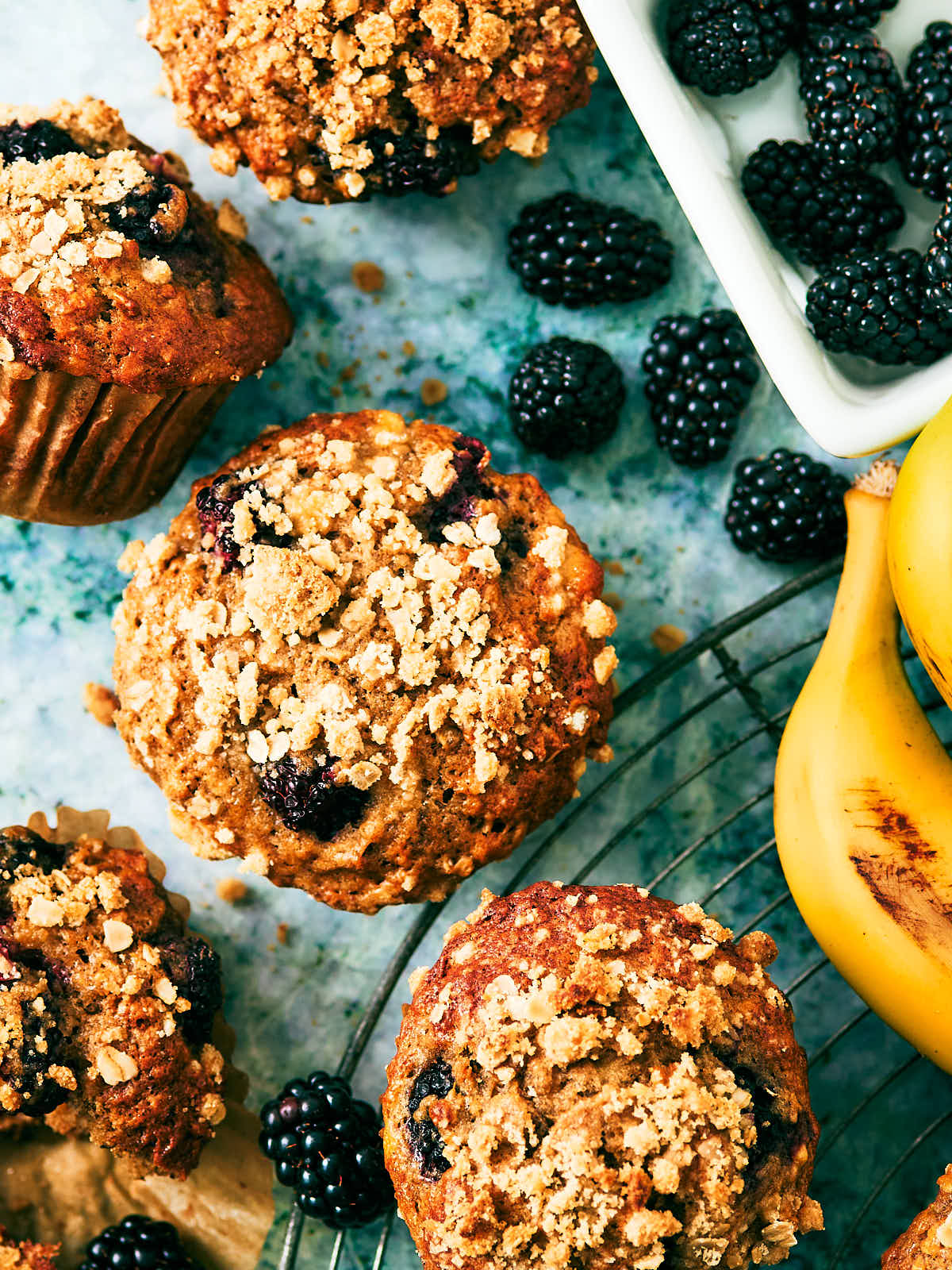 Banana Blackberry Muffins with oat streusel on a cooling rack.