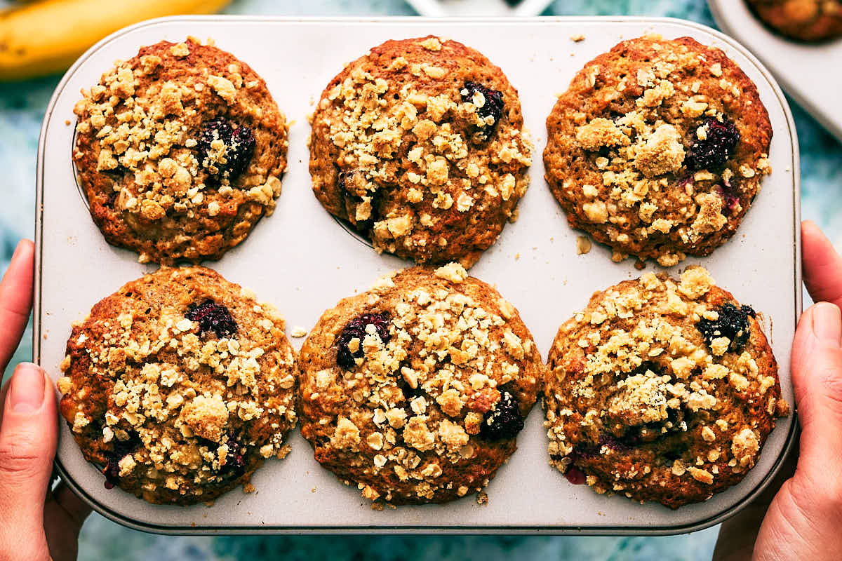 Evergreen Kitchen Banana Blackberry Muffins with oat streusel in muffin tin.