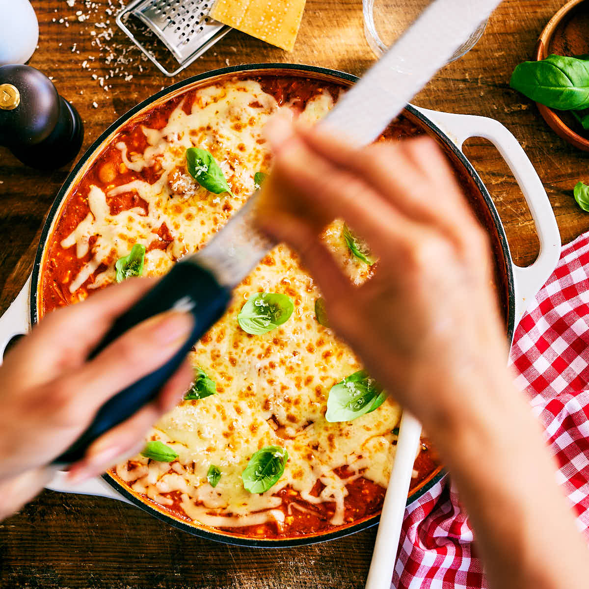 Vegetarian High Protein Pizza Beans being garnished with parmesan and basil.