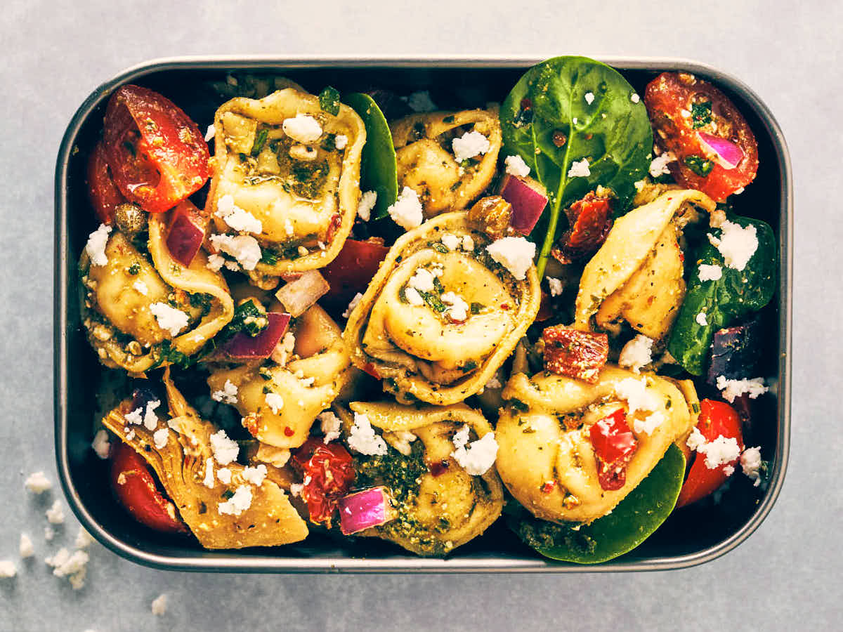 Evergreen Kitchen's Pesto Tortellini Pasta Salad in a meal prep container.