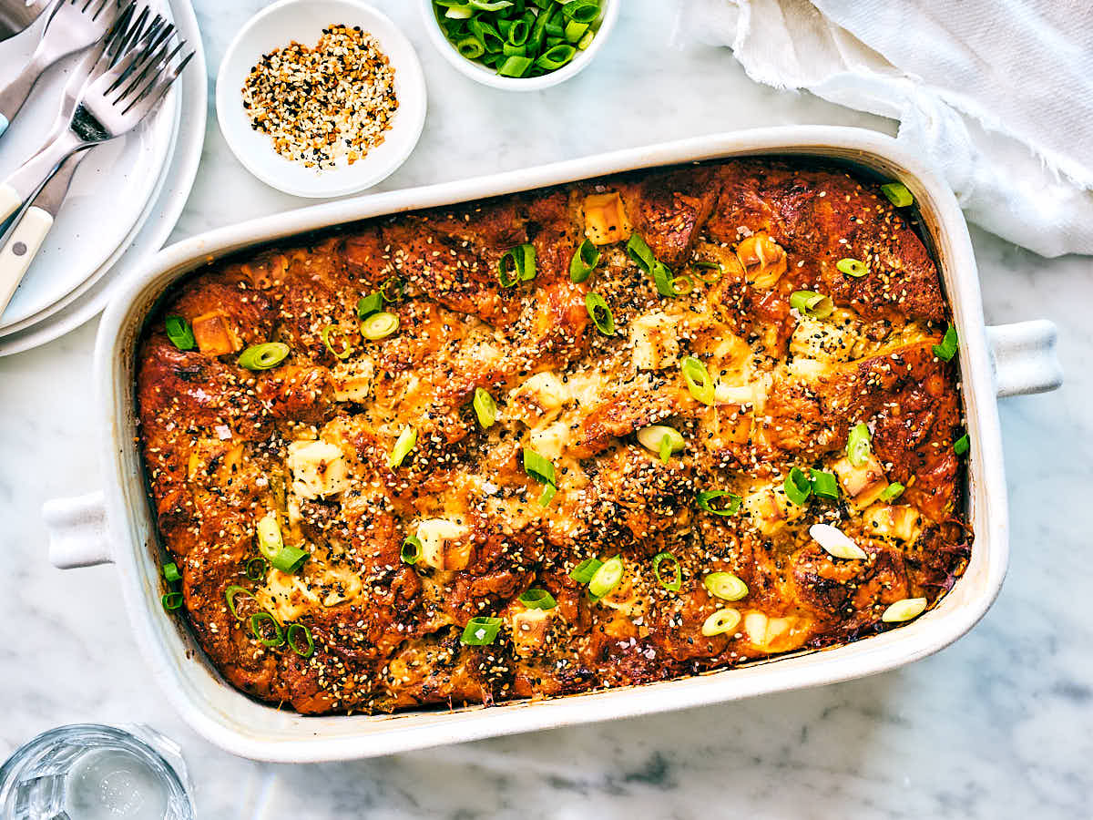Vegetarian Bagel Breakfast Bake in a casserole dish on a marble counter.