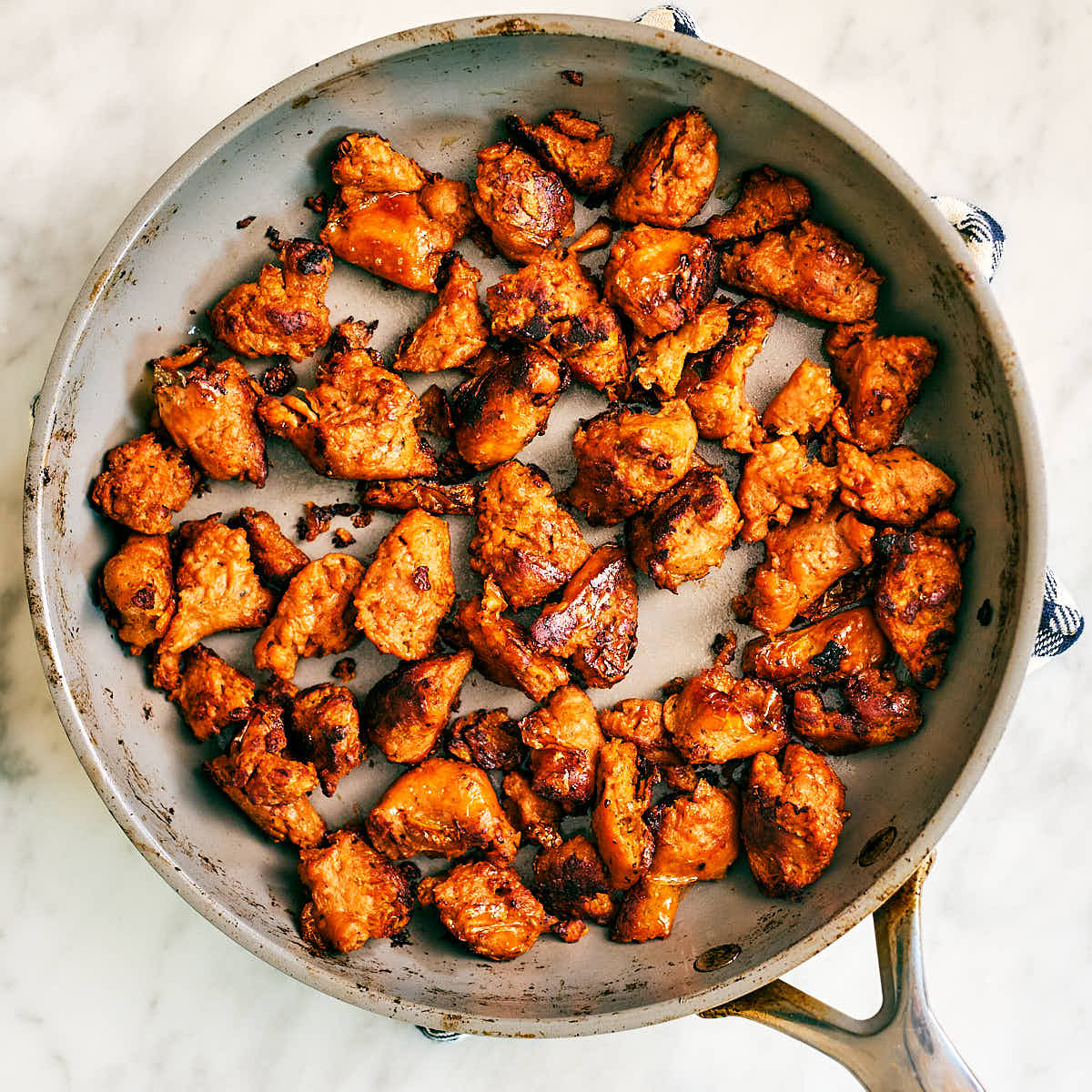 Plant-based sausage crumbles sauteed in a non-stick skillet.