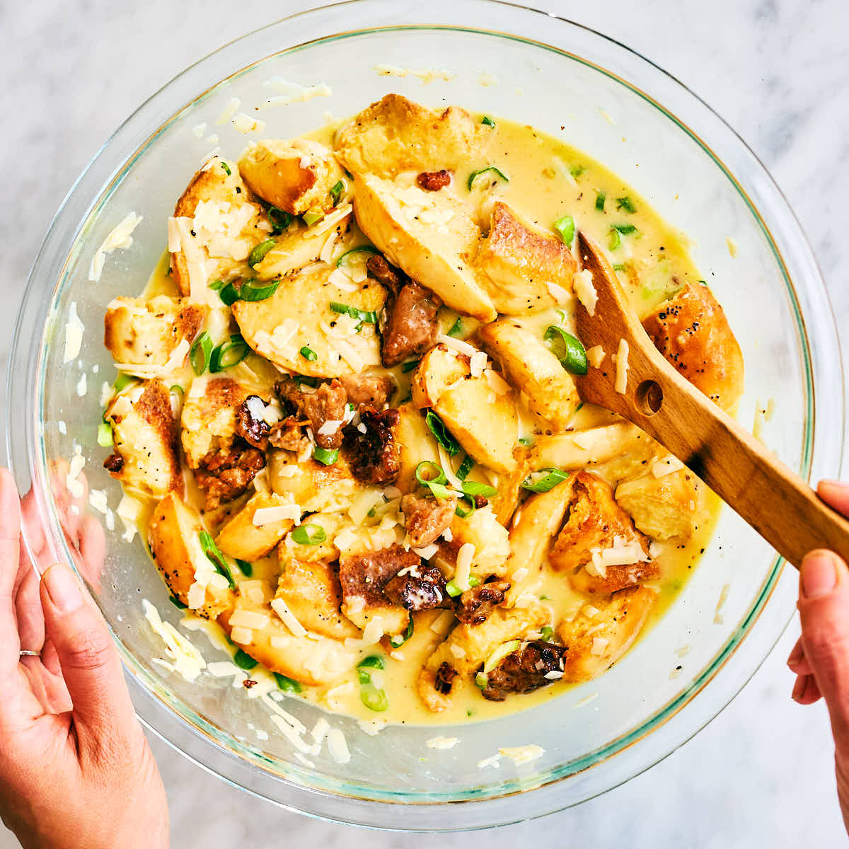 Vegetarian bagel breakfast casserole mixed in a bowl before baking.