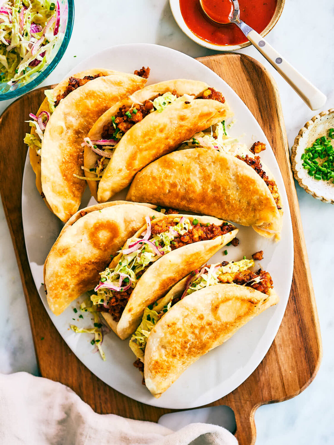 Crispy Sheet Pan Tacos made with barbecue sauce tofu and cabbage slaw on a serving plate.