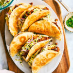 Crispy Sheet Pan Tacos made with barbecue sauce tofu and cabbage slaw on a serving plate.