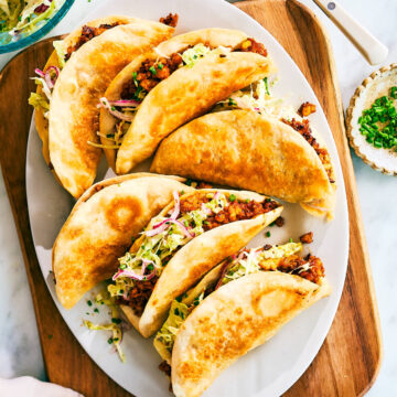 Crispy Sheet Pan Tacos made with barbecue sauce tofu and cabbage slaw on a serving plate.
