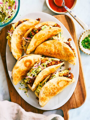 Crispy Sheet Pan Tacos made with barbecue sauce tofu and cabbage slaw on a serving plate.
