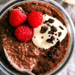 Evergreen Kitchen's Chocolate Chia Pudding topped with yogurt and raspberries.