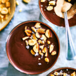 Chocolate Peanut Butter Cup Chia Pudding in cups with a spoon.