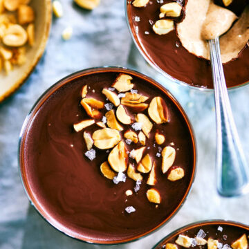 Chocolate Peanut Butter Cup Chia Pudding in cups with a spoon.