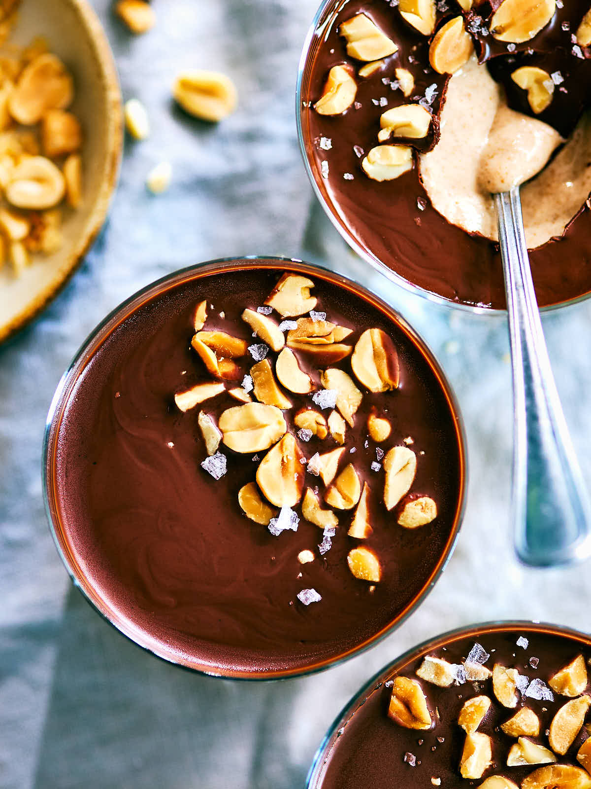 Chocolate Peanut Butter Cup Chia Pudding in cups with a spoon.