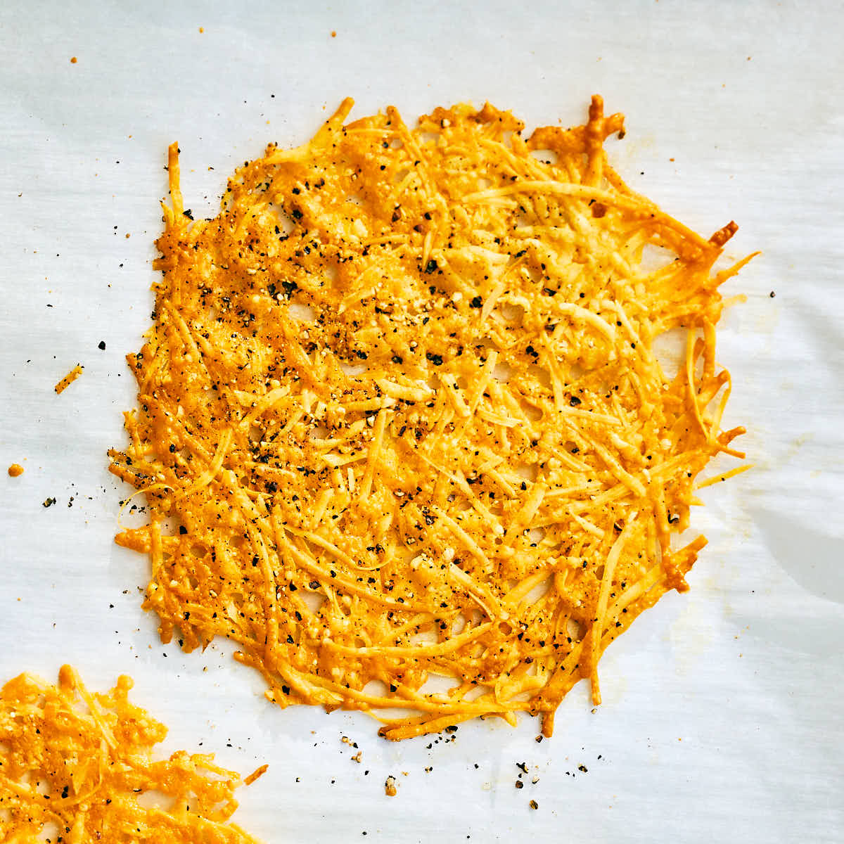 Melted parmesan cheese crisps with black pepper.