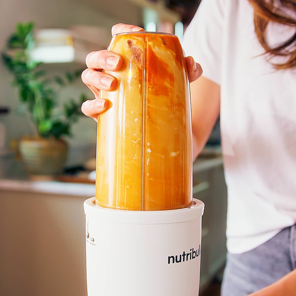 Blending wet ingredients for pumpkin protein muffins.