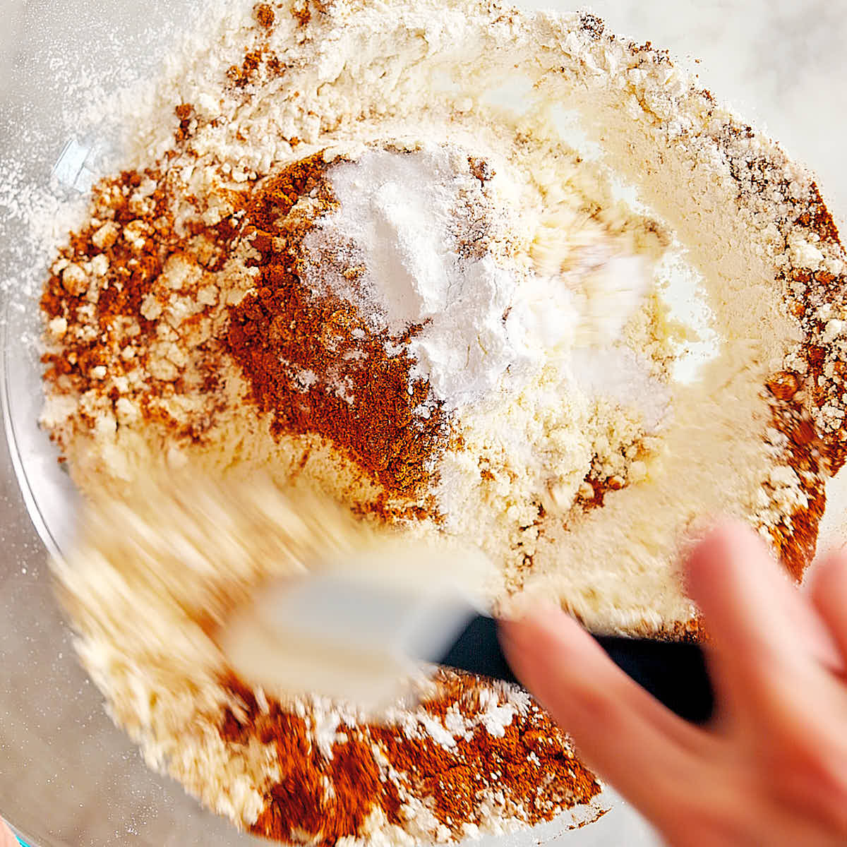 Dry ingredients for high protein pumpkin muffins being mixed in a bowl.