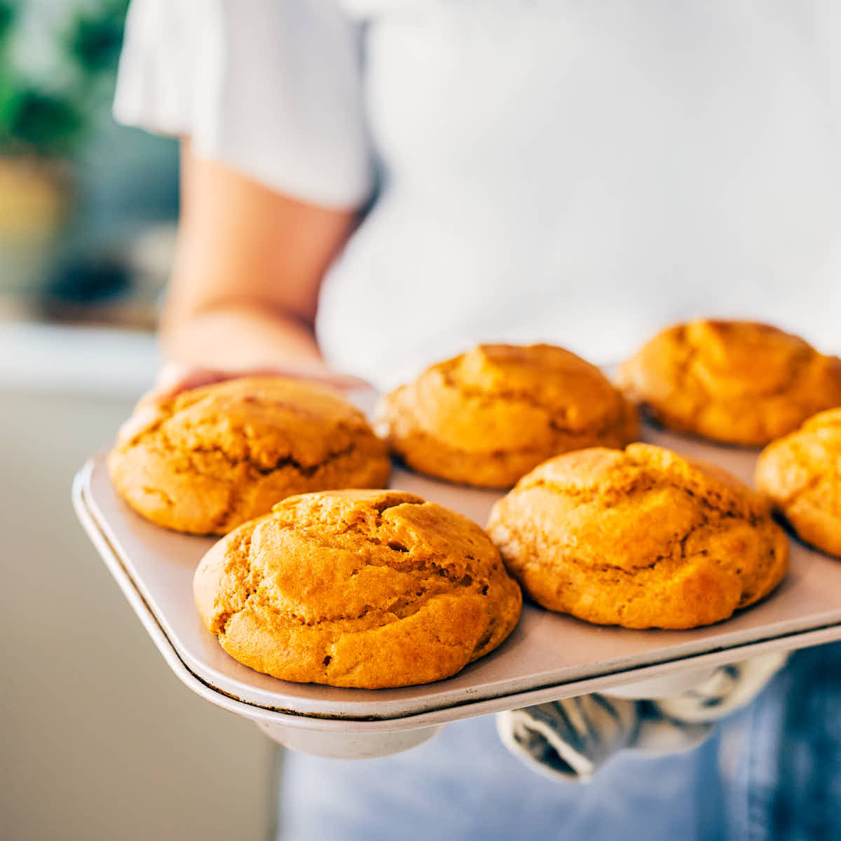 Evergreen Kitchen's Pumpkin Protein Muffins in a muffin tin after baking.